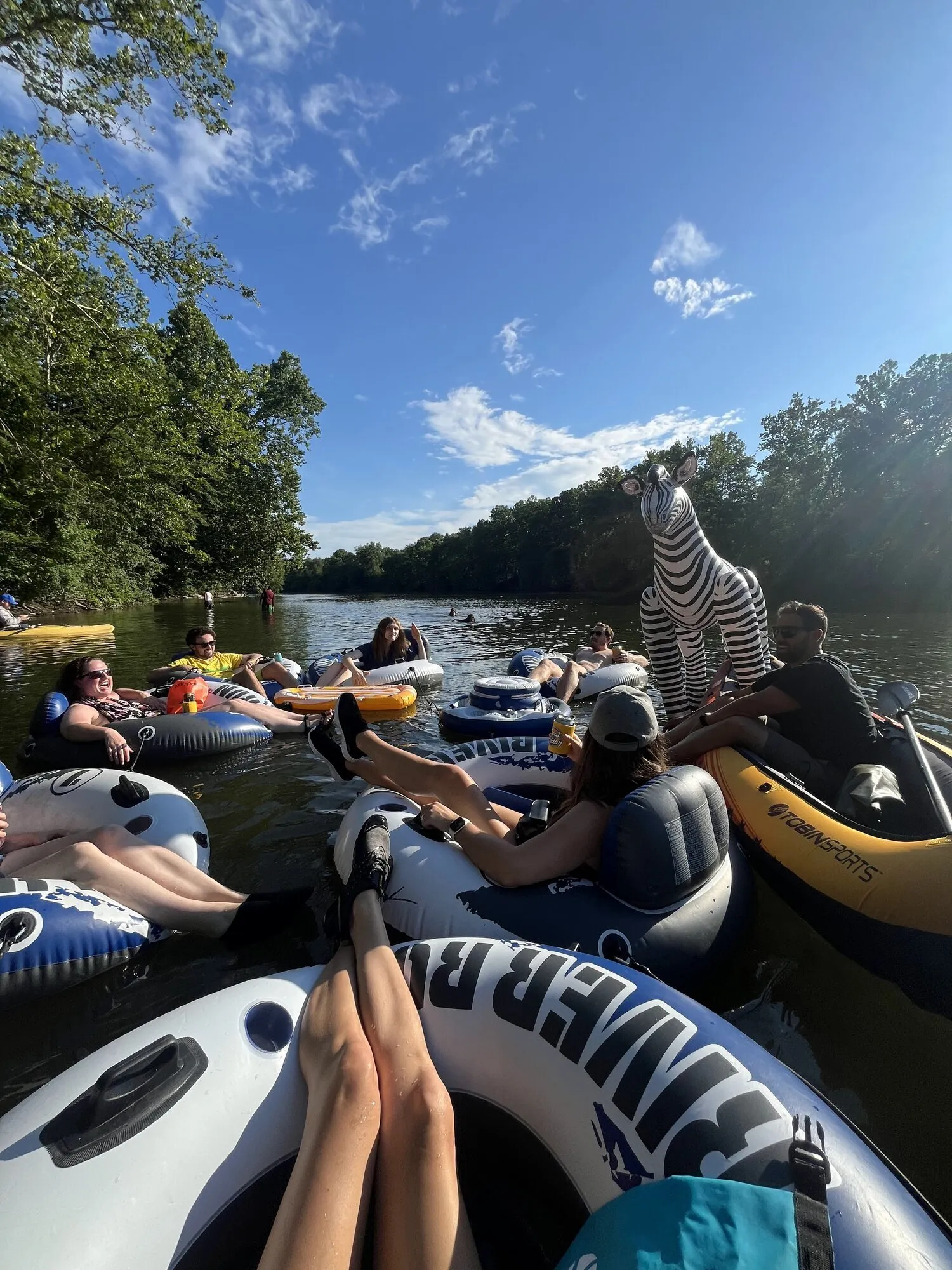 Group on creek with zebra inflatable