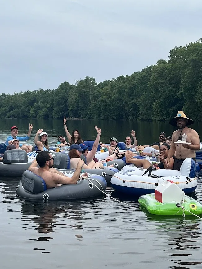 Group raft-up with hands raised on an overcast day